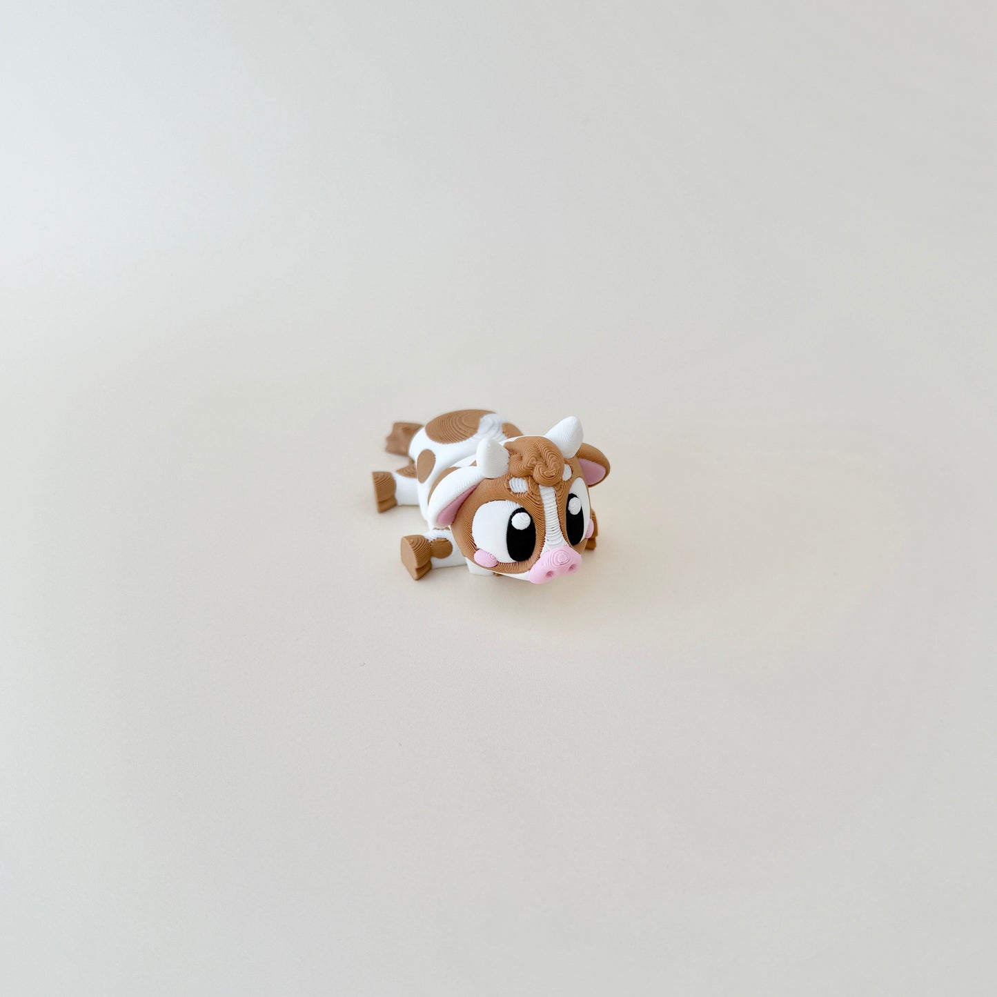 A baby cow fidget toy designed for stress relief and sensory stimulation.