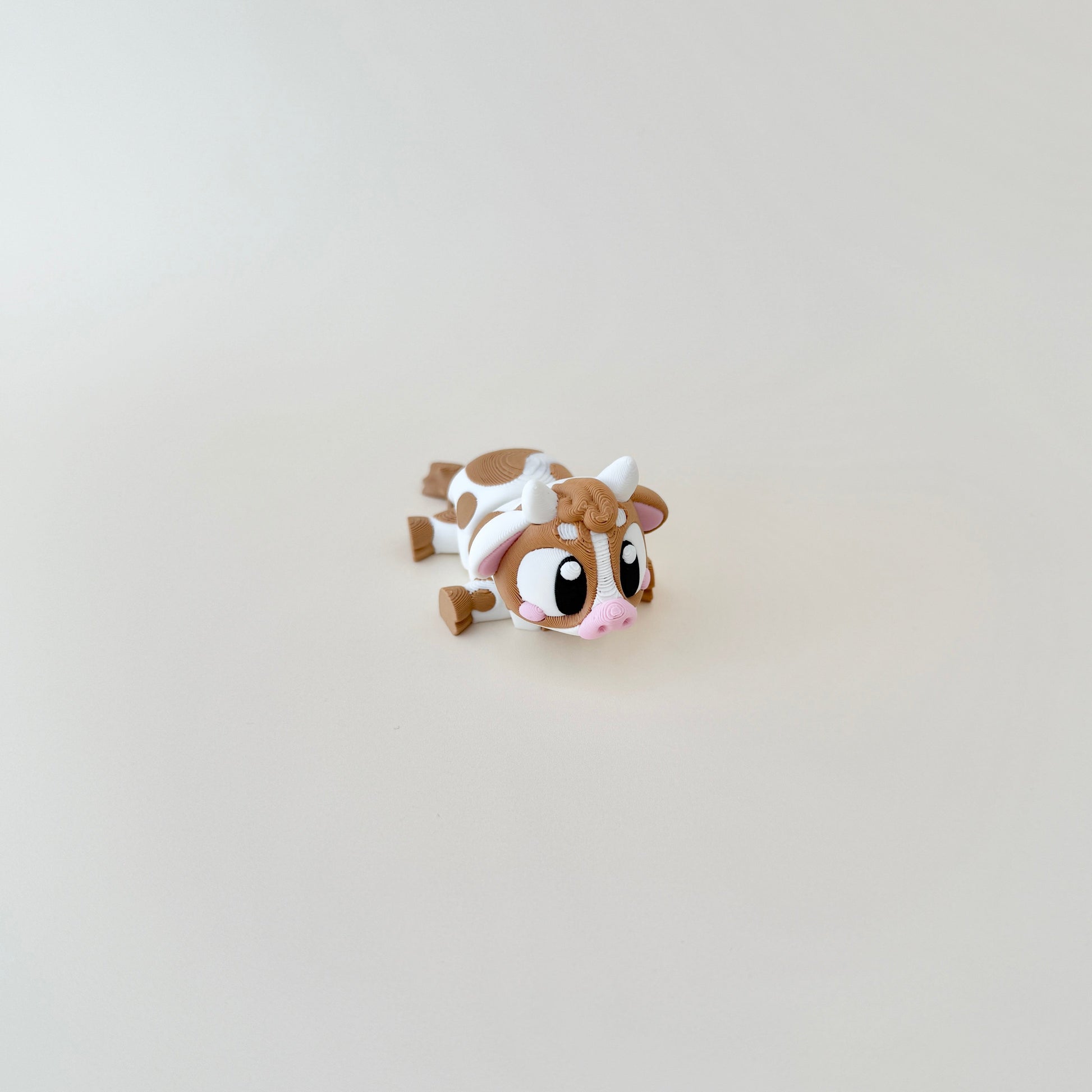 A baby cow fidget toy designed for stress relief and sensory stimulation.