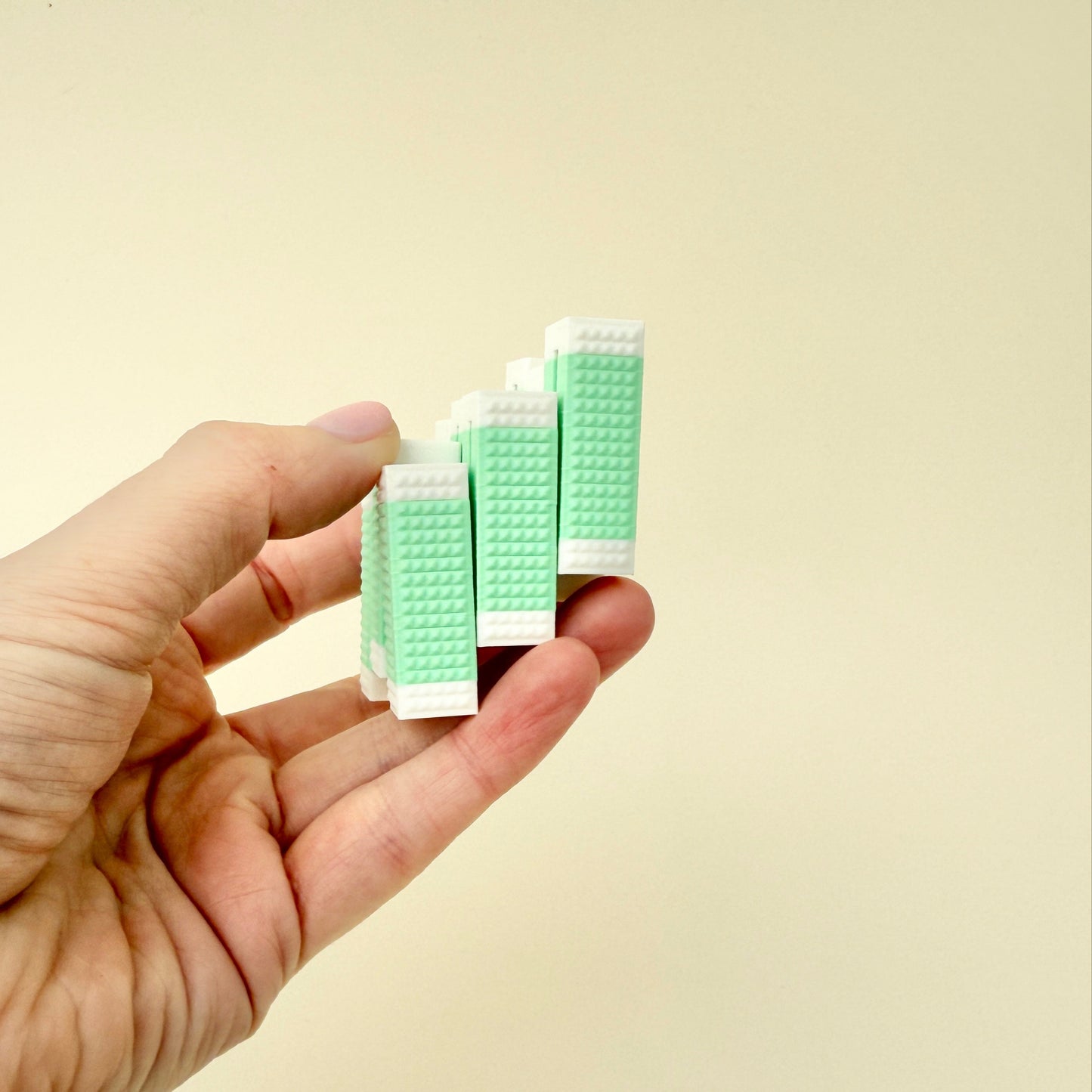 A small, handheld fidget block designed for movement, featuring a textured surface for grip and sensory play.