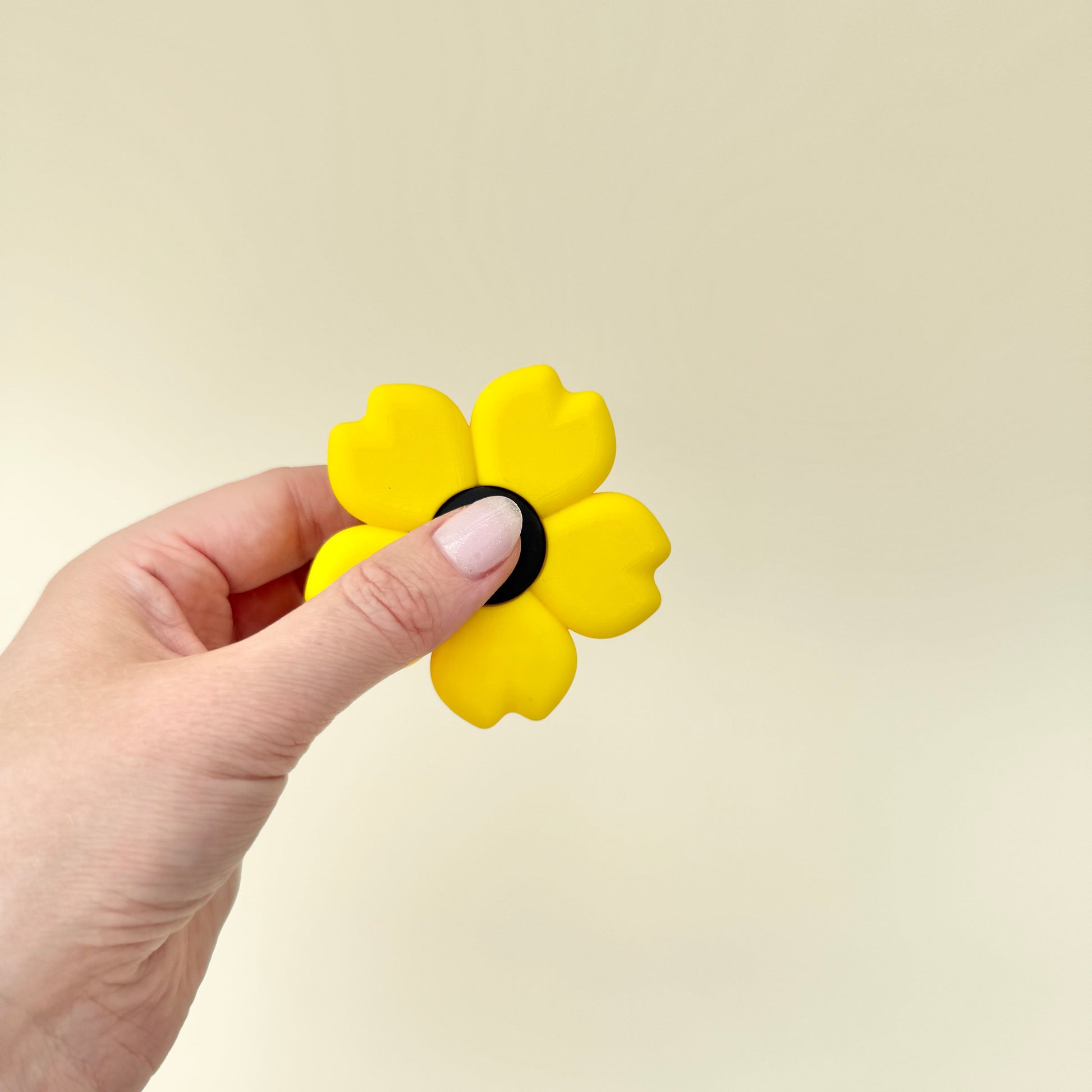 Flower-shaped spinner with textured petals and a quiet spin for fidgeting