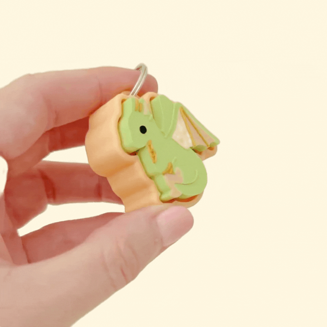 Small fidget clicker shaped like a dragon, great for on-the-go sensory support.