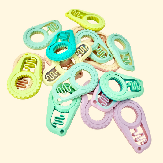 Tactile finger stim toy with a rotating edge and clicking sound.
