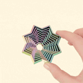 A ShapeShifters Star fidget toy with a layered, colour-changing design displayed on a flat surface.