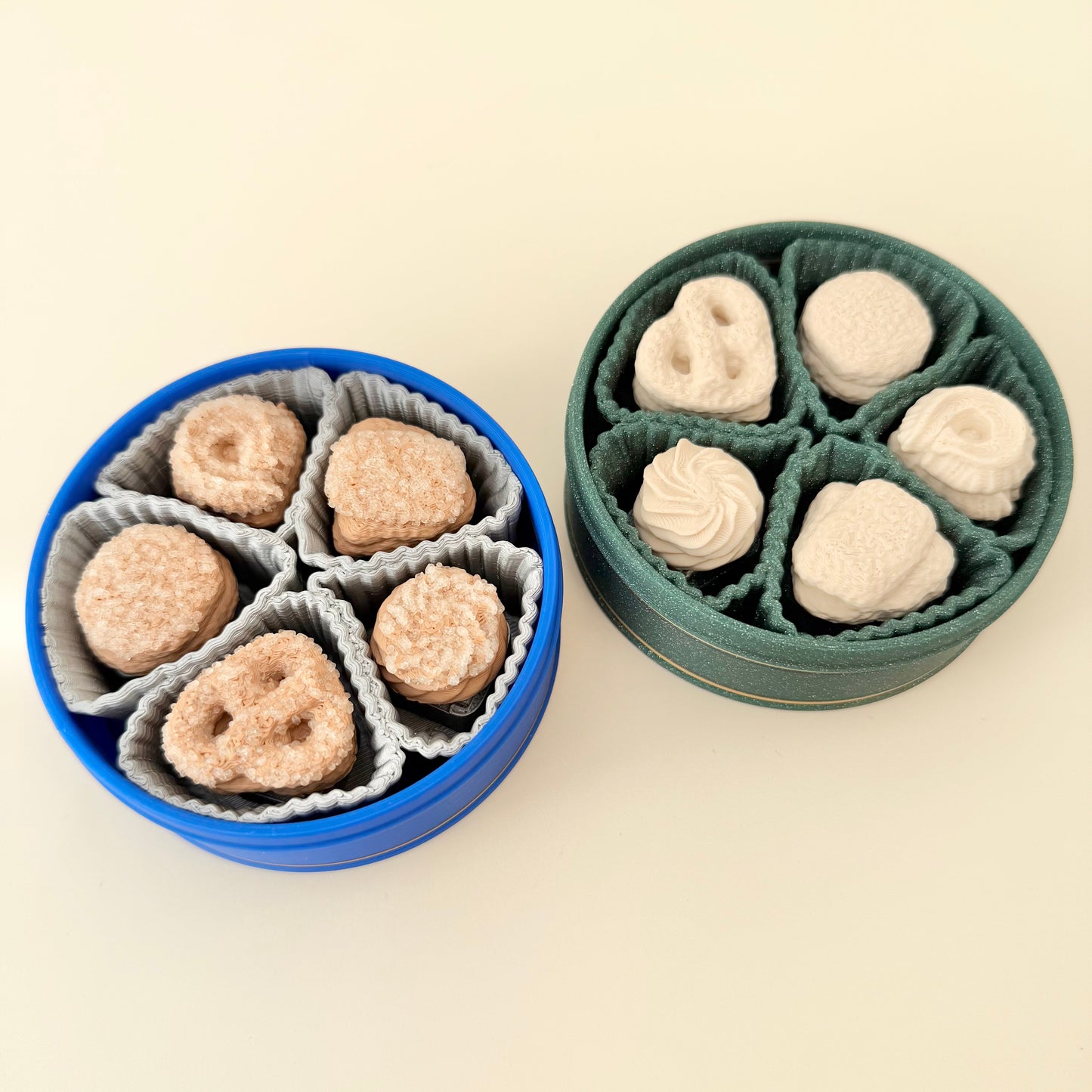 Set of five biscuit-shaped clickers with ridges and swirl textures; snug fit in a reusable tin; everyday desk fidget.
