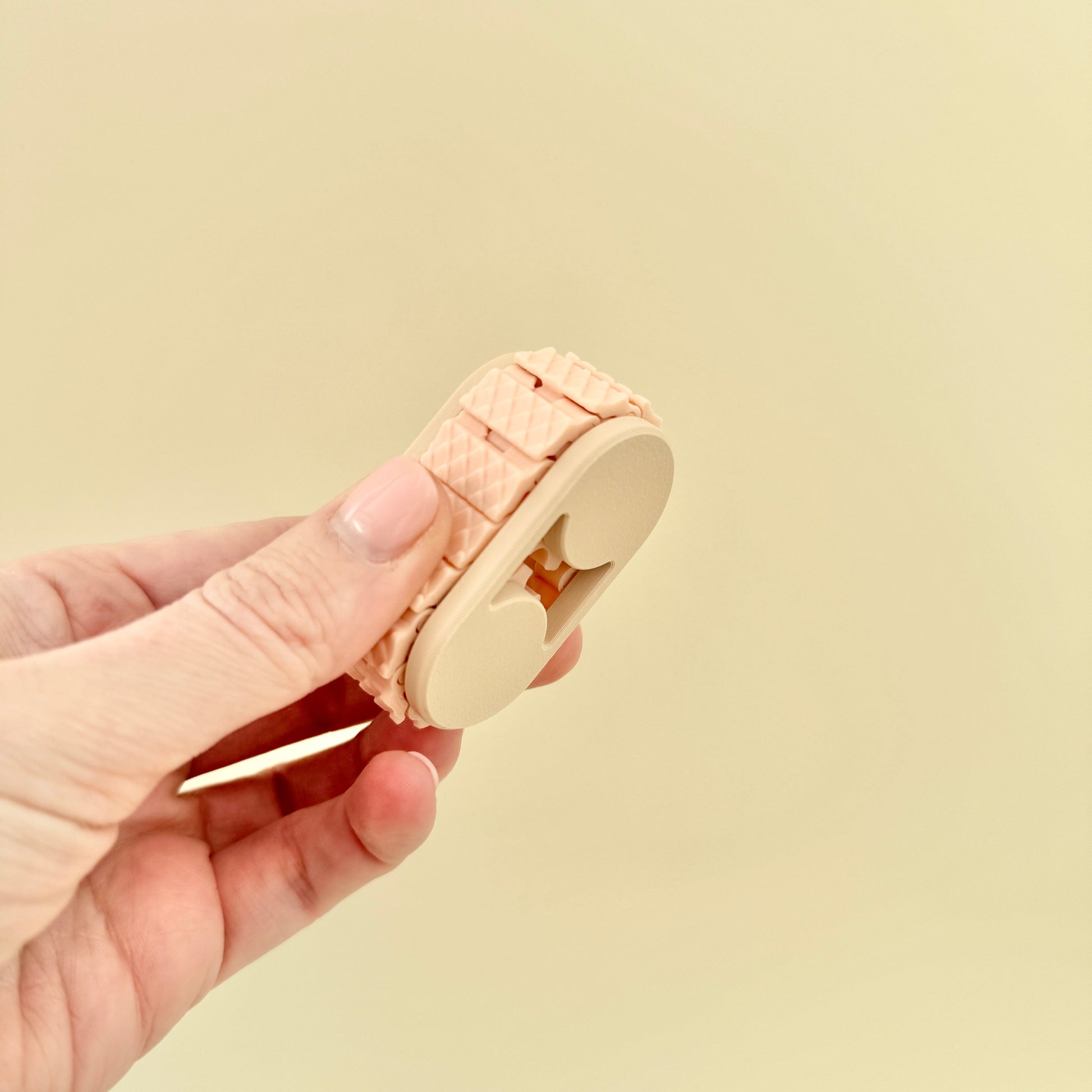 A silent fidget tool designed for rolling between the fingers, offering deep tactile feedback.