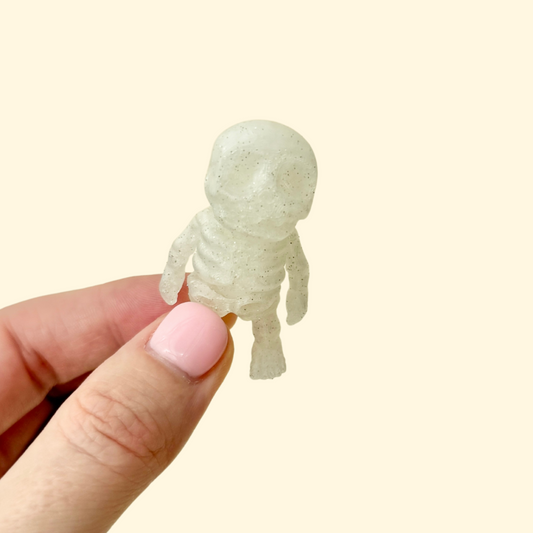 Small articulated skeleton fidget toy with a frosted silver glitter finish
