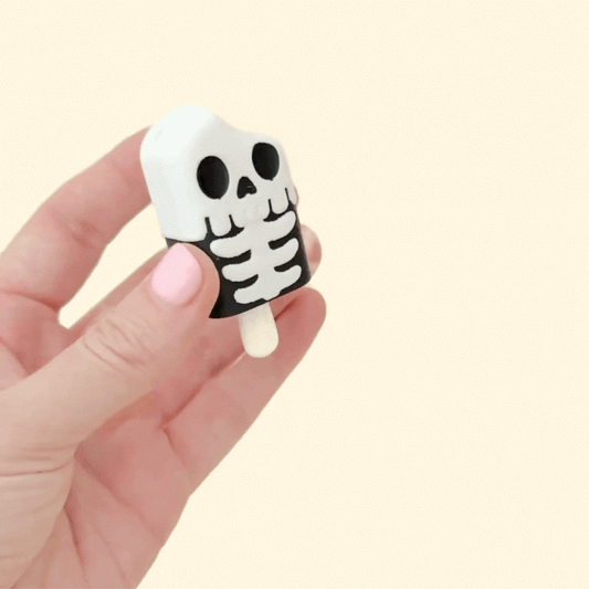 skeleton lolly shaped clicker fidget with keyring-ready attachment and tactile details
