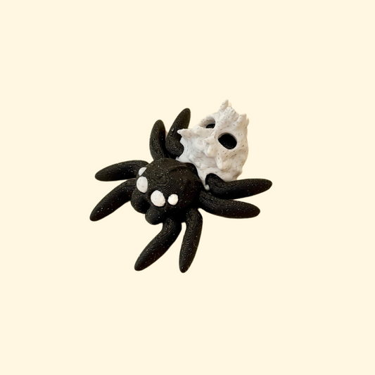 mini articulated spider fidget with sparkly black body and marbled skull detail for sensory play
