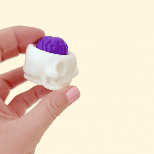 Halloween-inspired skull fidget with a brain button for focus and fun
