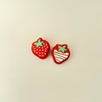 Compact strawberry-shaped clicker with textured detailing for sensory play.
