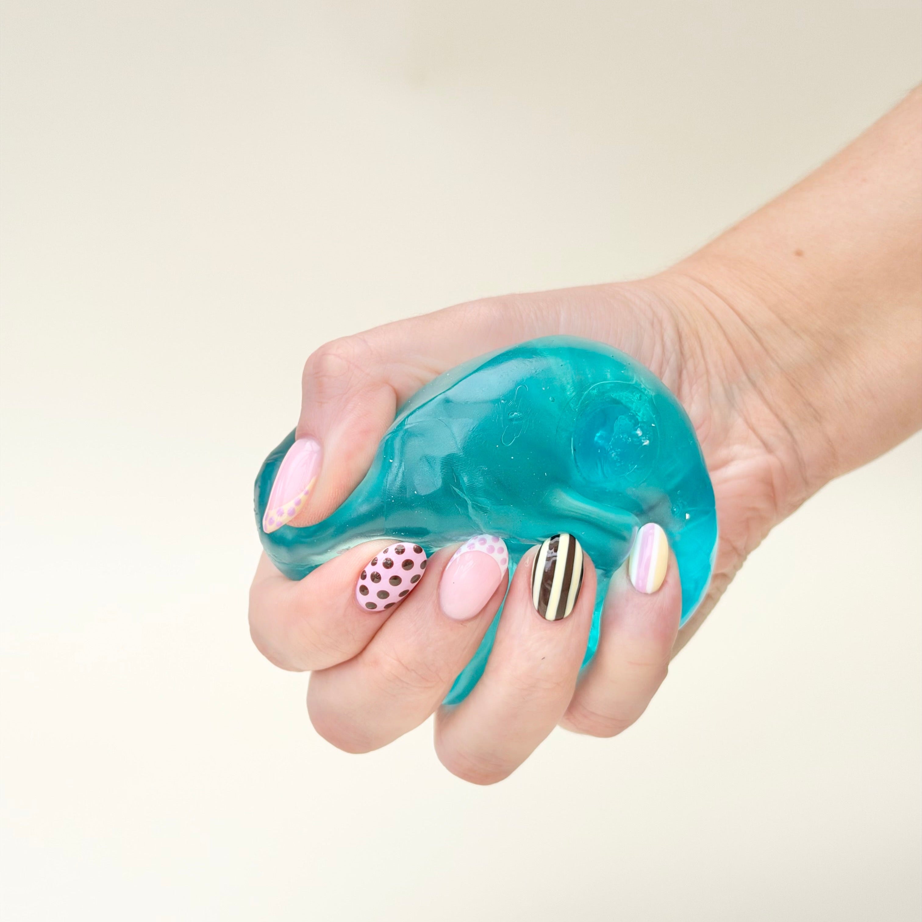 Tactile squishy fidget with soft raised bumps for tracing and calming hand movement during desk breaks and daily routines.
