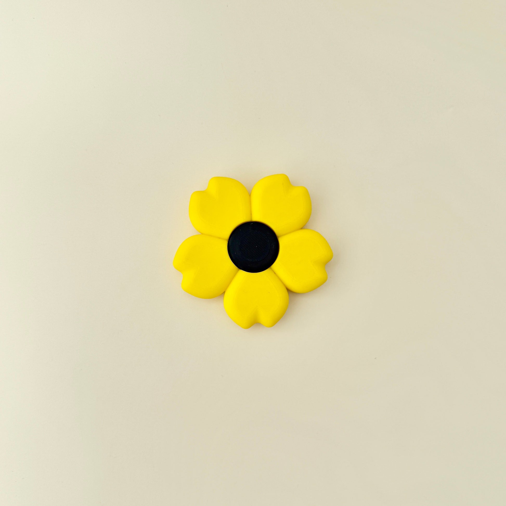 Bright sunflower fidget toy designed to spin between your fingers