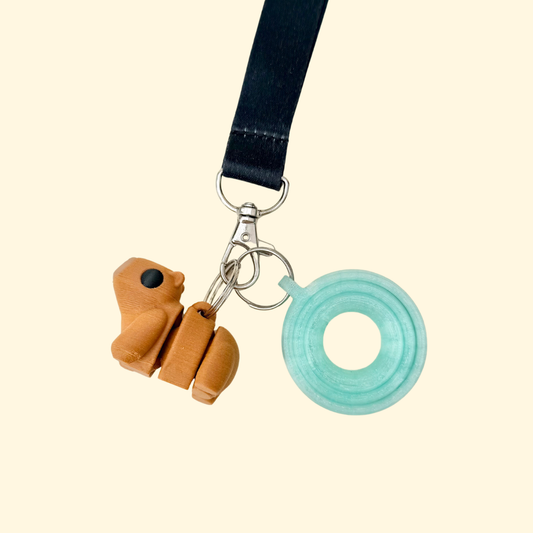 Wearable fidget add-on with smooth surfaces and subtle detailing for finger tracing and grounding.
