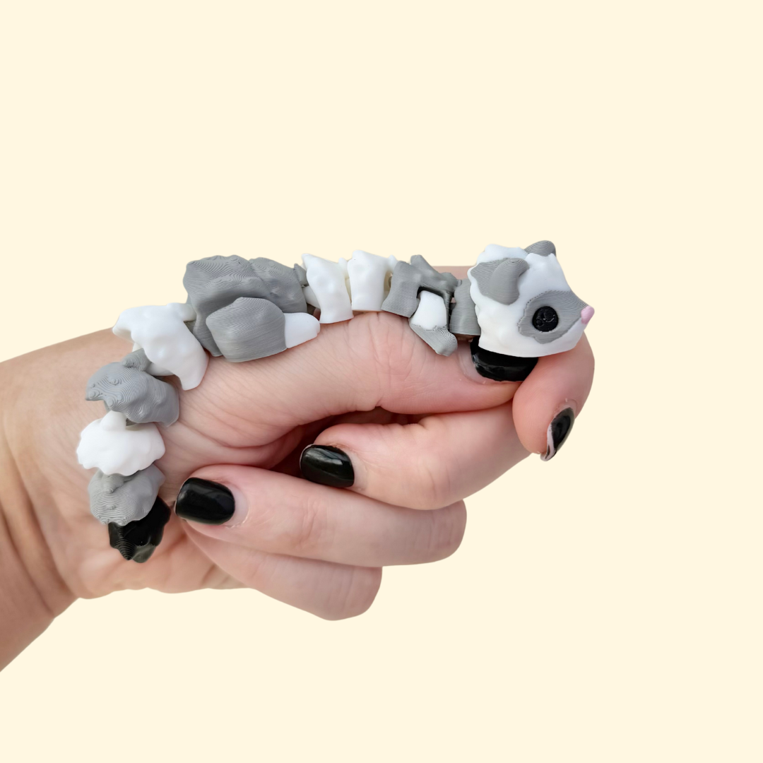 Fully articulated 11 cm ferret fidget with subtle texture for tactile input; quiet, desk-safe and portable.
