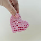 Compact heart-shaped sensory fidget designed for quiet, satisfying hand movement and tactile tracing.
