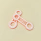Dual-ended fidget spinner with tactile rings and rotating stim bar for sensory input and fidget use.