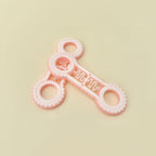 Dual-ended fidget spinner with tactile rings and rotating stim bar for sensory input and fidget use.