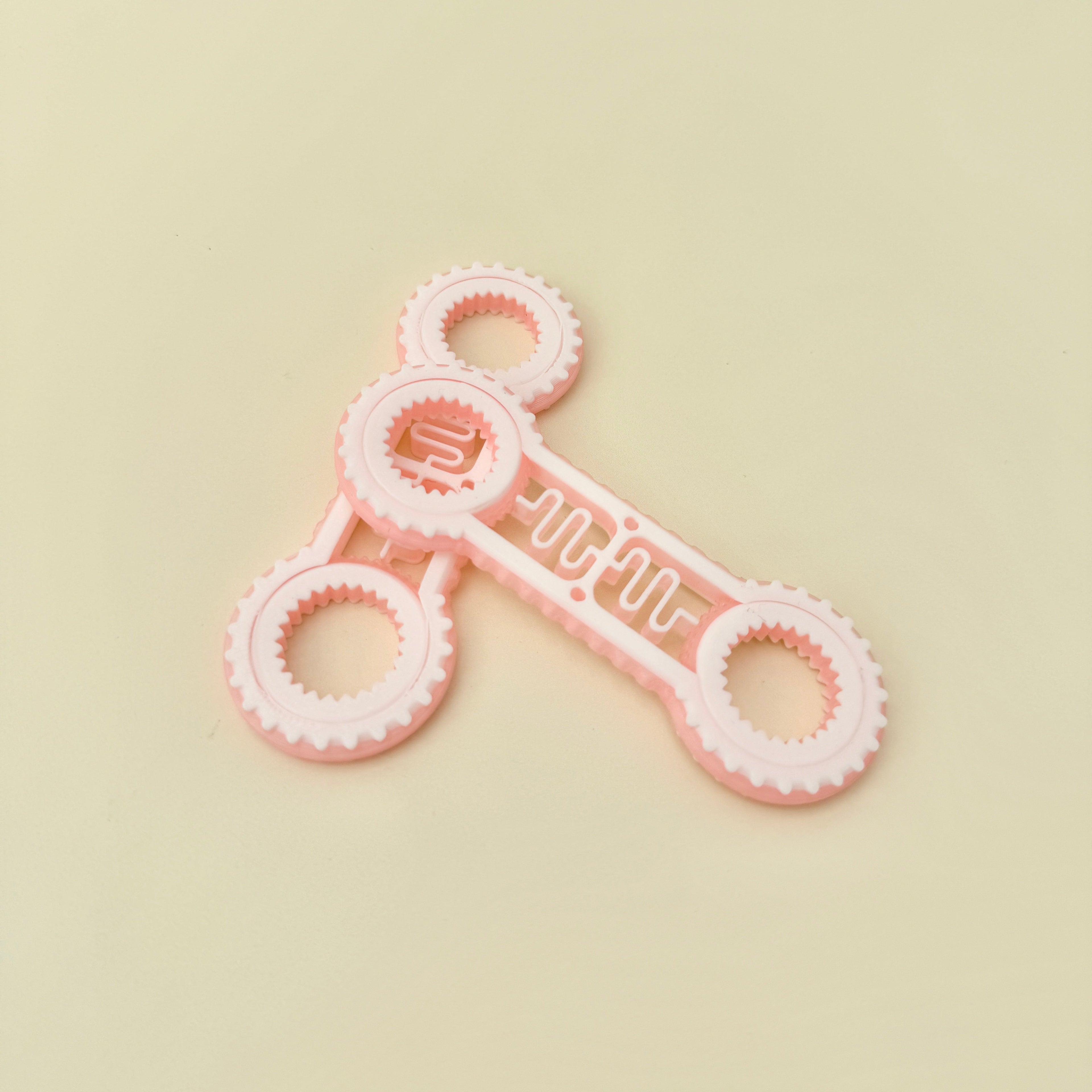 Dual-ended fidget spinner with tactile rings and rotating stim bar for sensory input and fidget use.