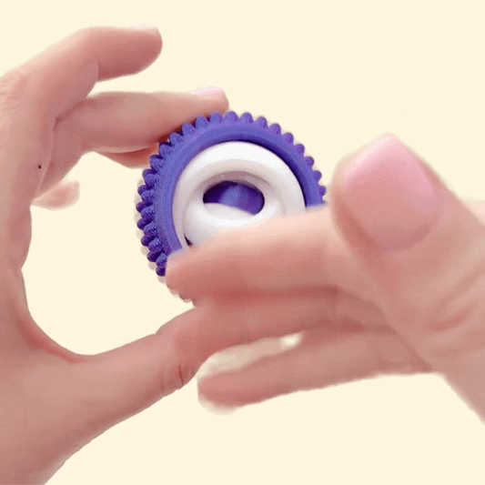Purple and white quad spinner for tactile stimming.
