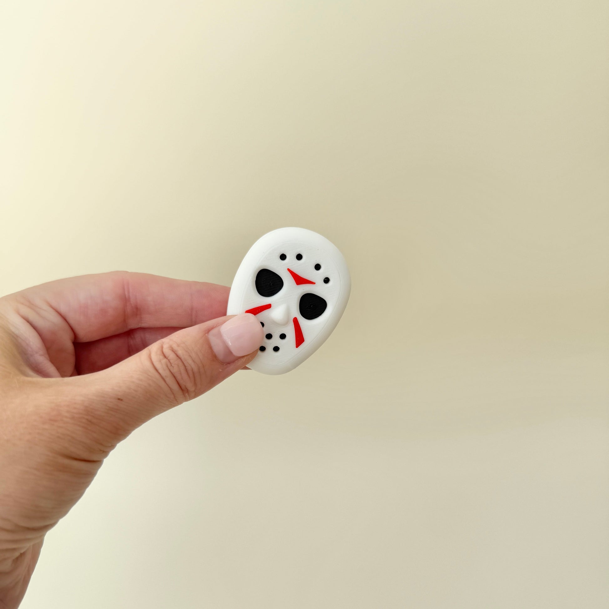 Magnetic sensory fidget with raised textures for tracing, sliding and repeatable motion.