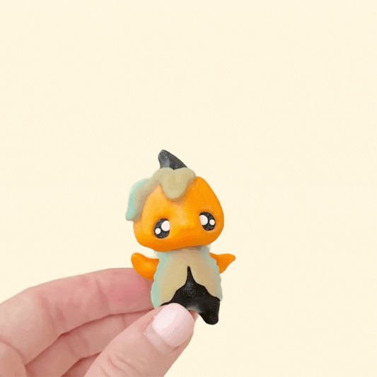Mini seasonal pixie fidget with raised textures and subtle ridges for thumb tracing.
