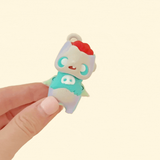 Compact collectible pixie with keyring attachment and calming fidget features.
