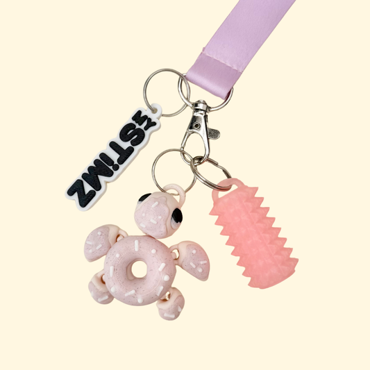 Raised sprinkle texture on a cute turtle add-on designed for lanyards, for tactile tracing and discreet sensory fidgeting.
