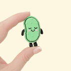 Blushing pickle fidget toy that stands upright and features different textures for sensory input.