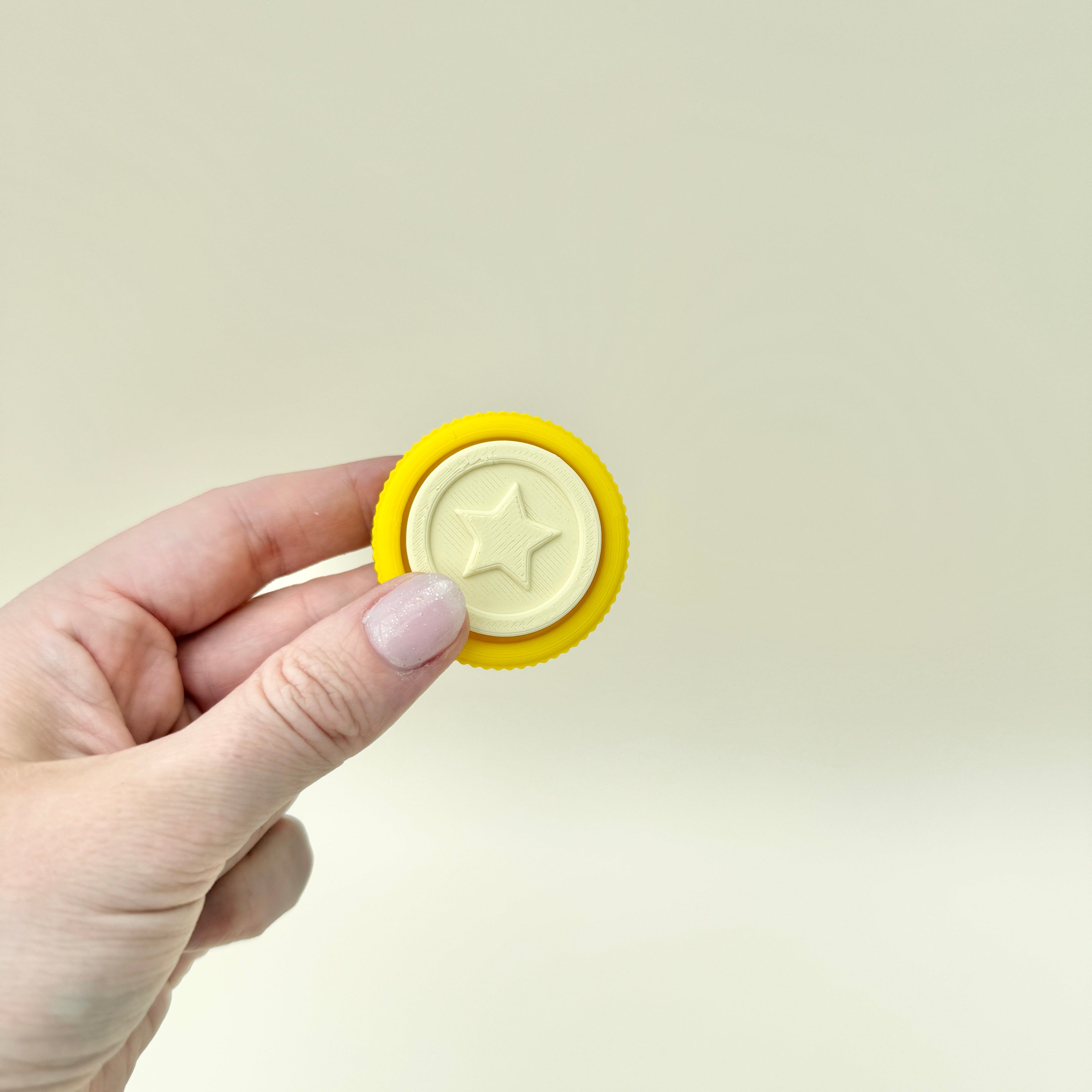 Yellow sensory clicker designed as a fun school reward or desk toy.