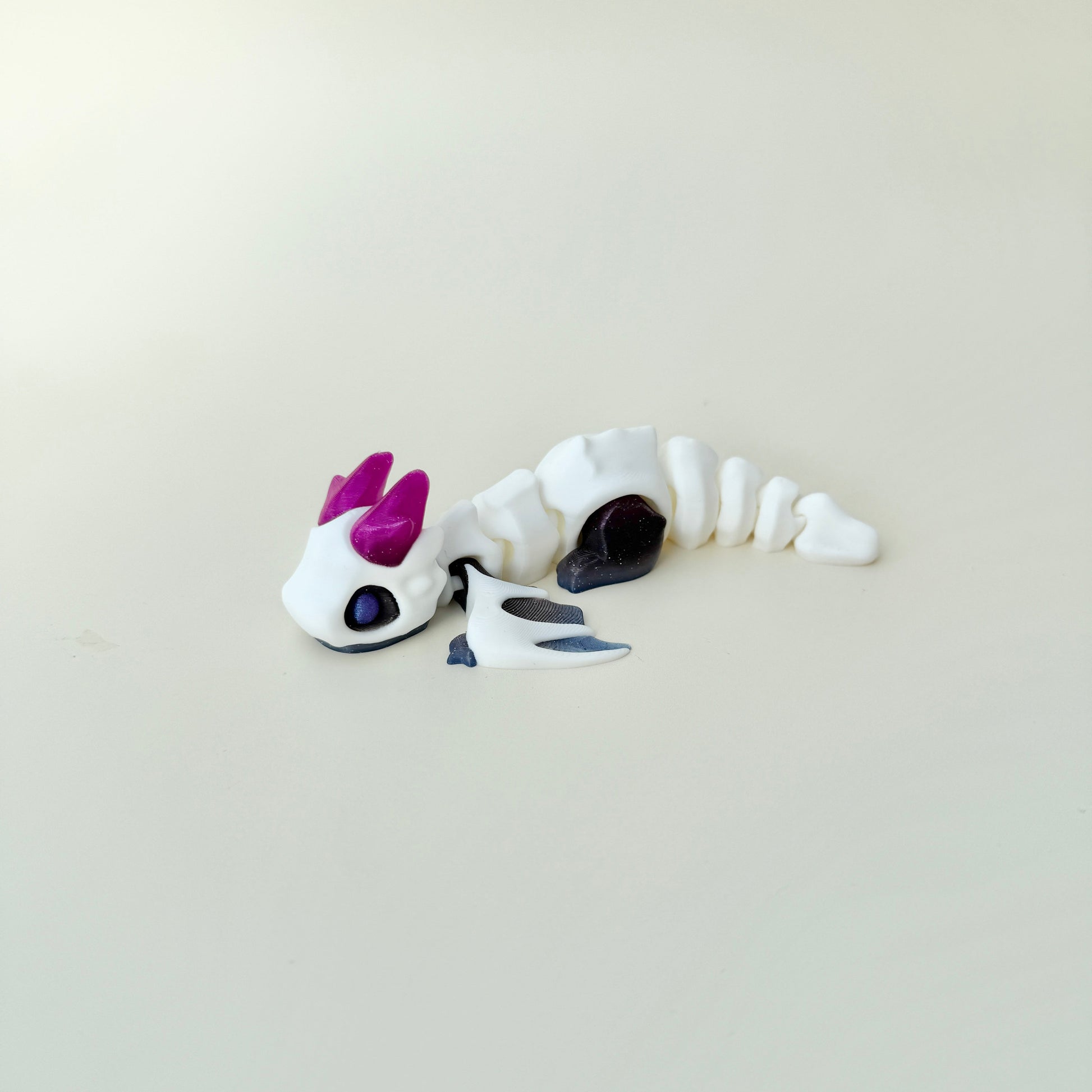 Winged dragon fidget with smooth links and gentle texture for repetitive motion and focus; collectable, limited edition.
