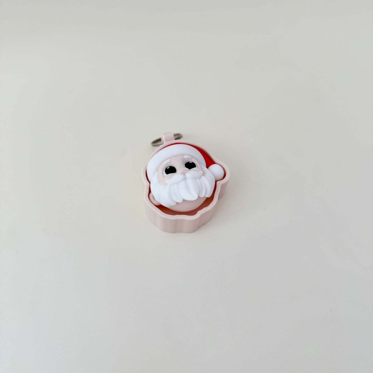 Compact holiday fidget, 3D Santa head, keyring-ready, satisfying press action with quiet upgrade available.
