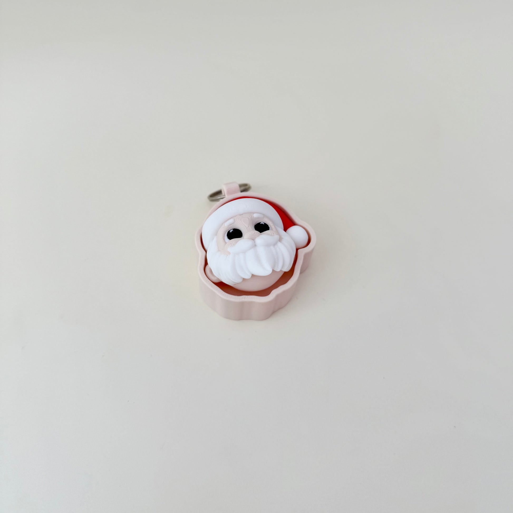 Compact holiday fidget, 3D Santa head, keyring-ready, satisfying press action with quiet upgrade available.
