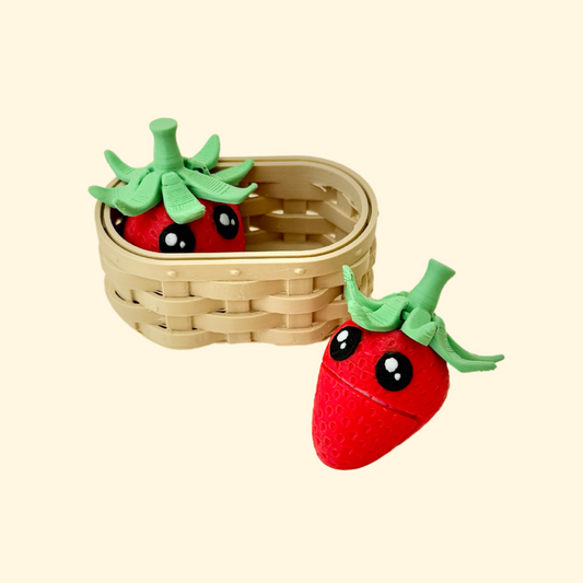 set of two strawberry fidgets with textured surfaces and a small basket holder for sensory use
