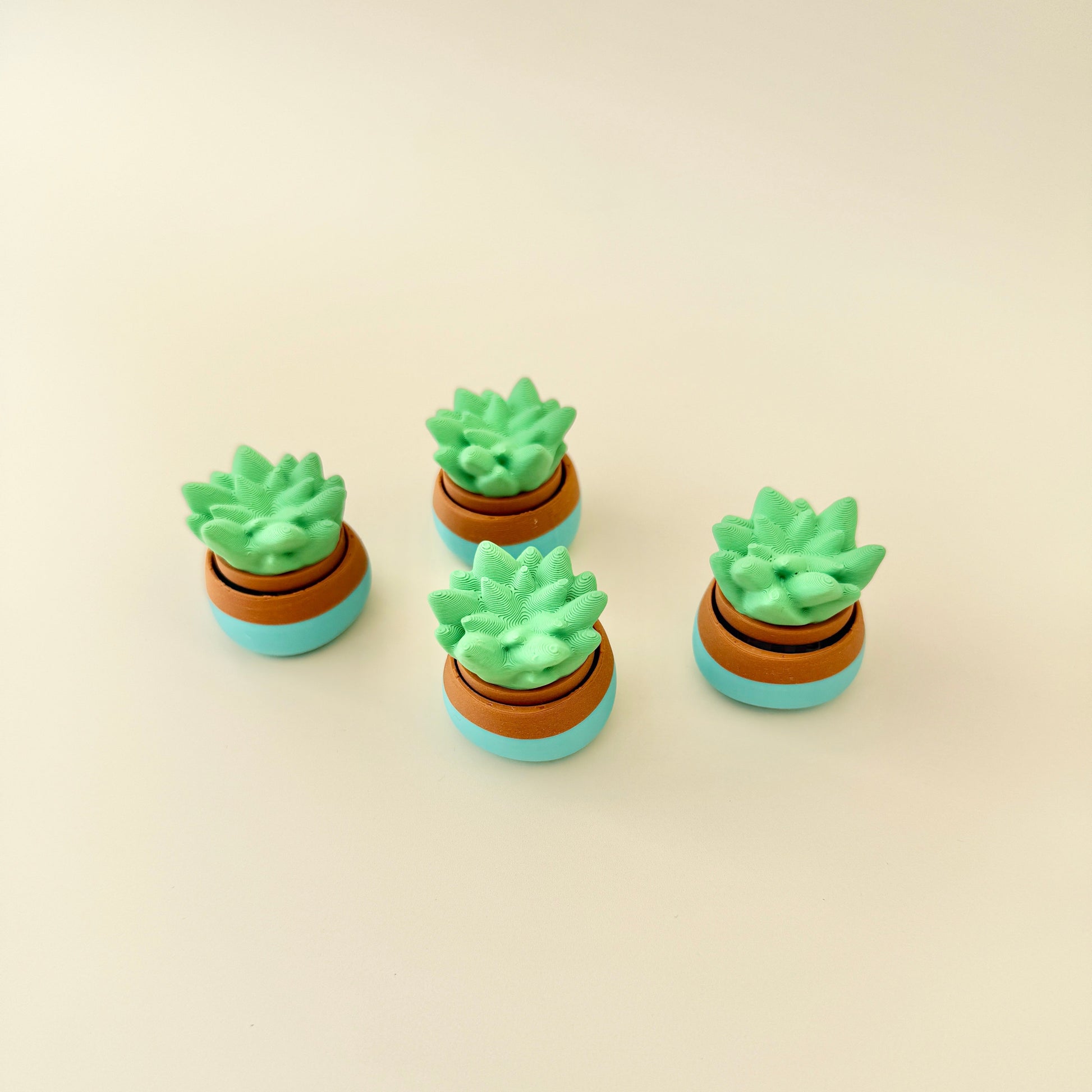 A fun sensory toy with a click mechanism, styled as a mini plant in a pot for relaxation and focus.
