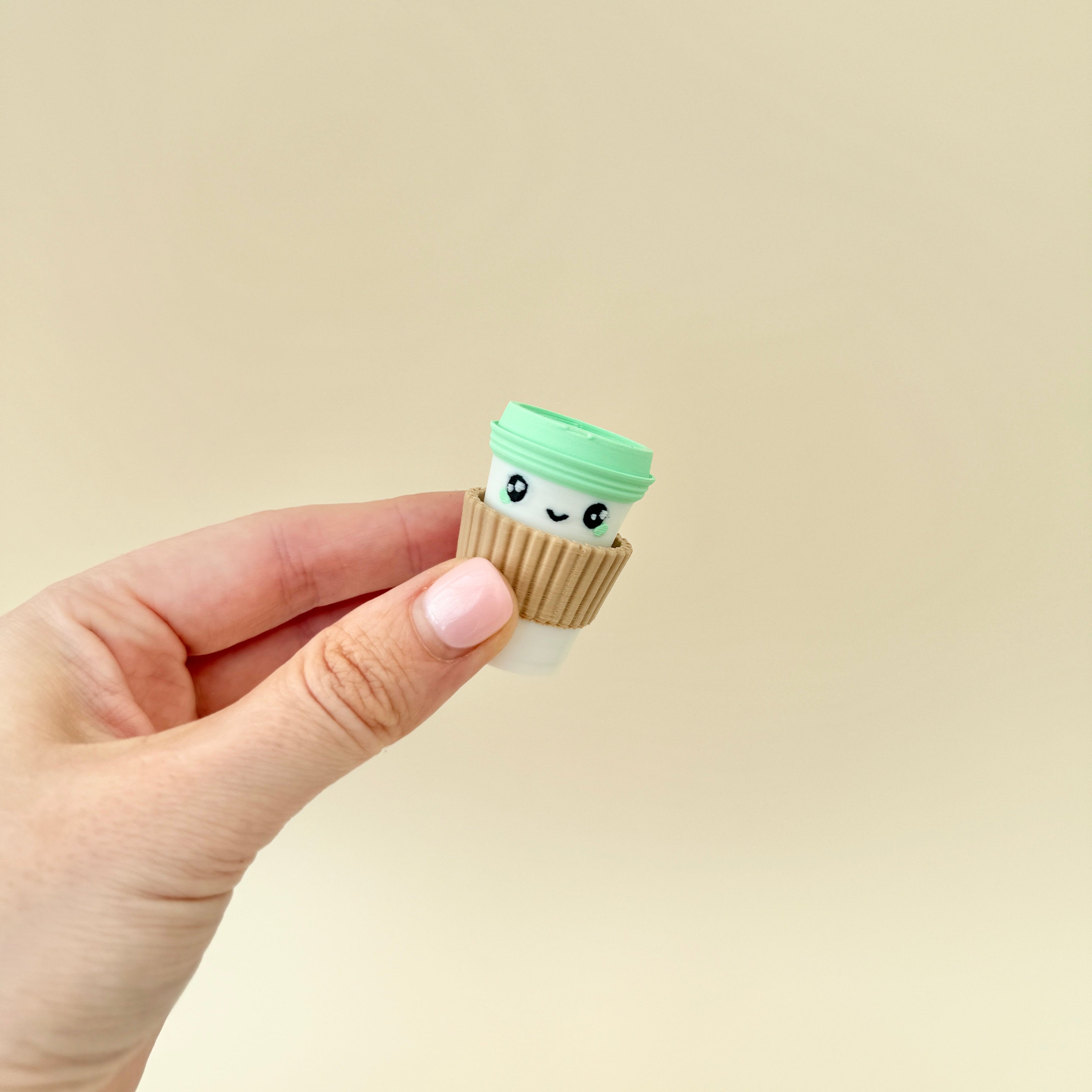 A small, café-inspired fidget toy that clicks when pressed, great for focus and relaxation.