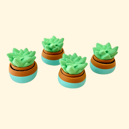 A small 3cm plant-themed fidget toy featuring a green succulent in a teal pot with a satisfying click function.