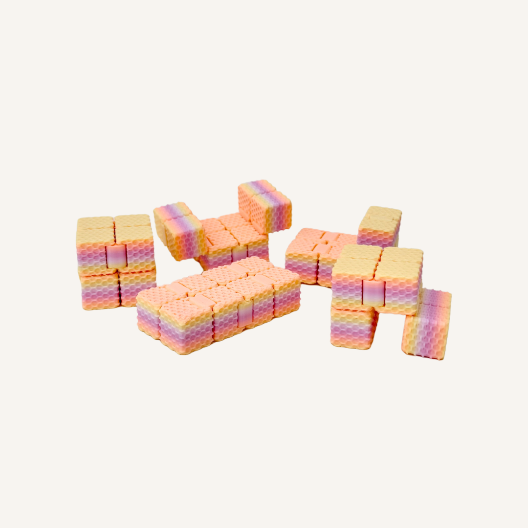 Textured mini fidget cube that flips and folds through shapes for satisfying one-handed sensory play.
