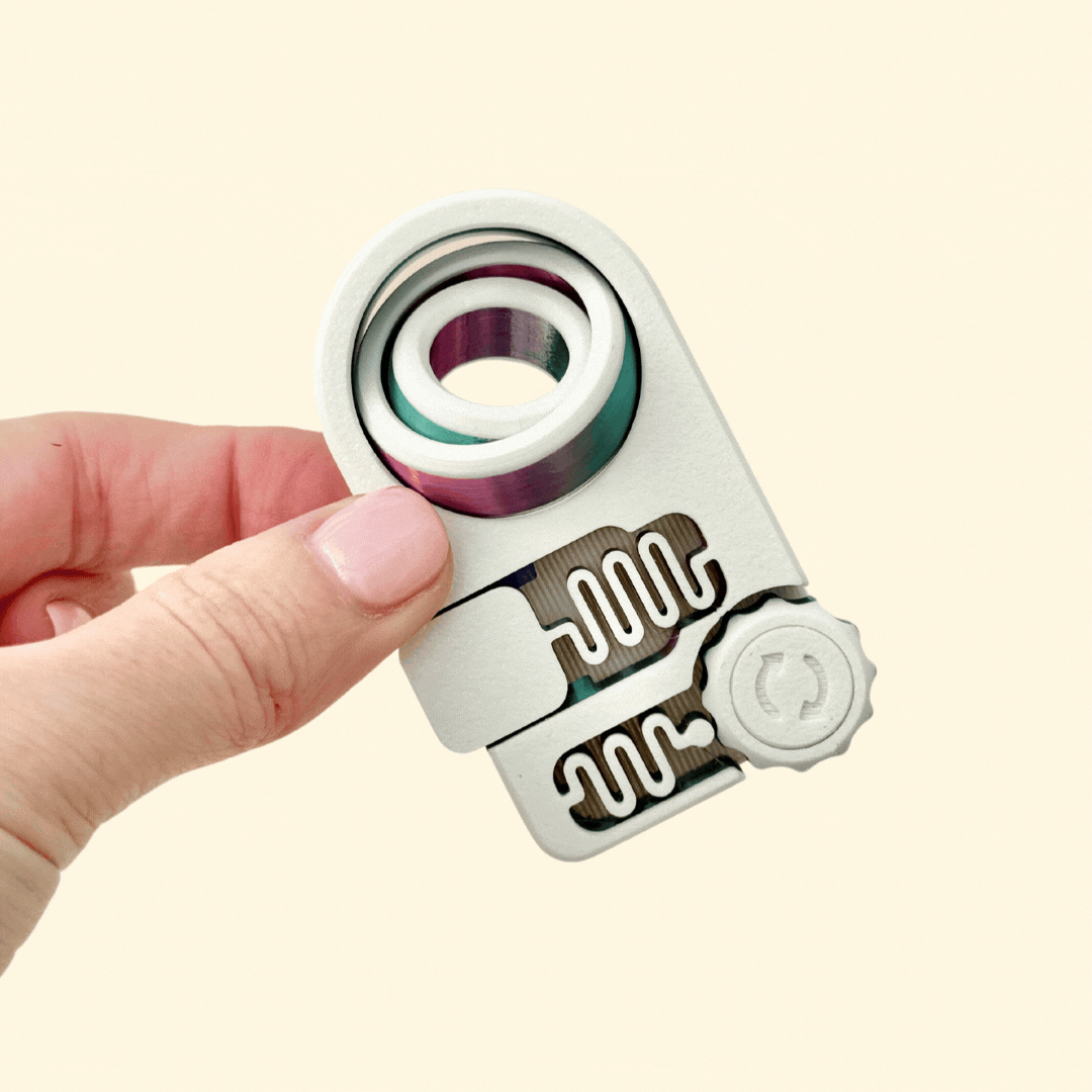 Compact sensory fidget toy designed for desk use, pocket carry, and stress relief with three interactive elements.