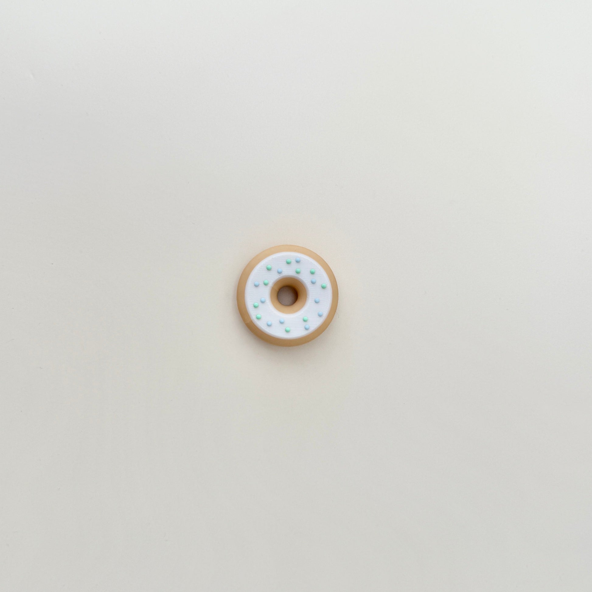 A smooth yet textured fidget toy with raised sprinkle details for added grip and a satisfying feel.