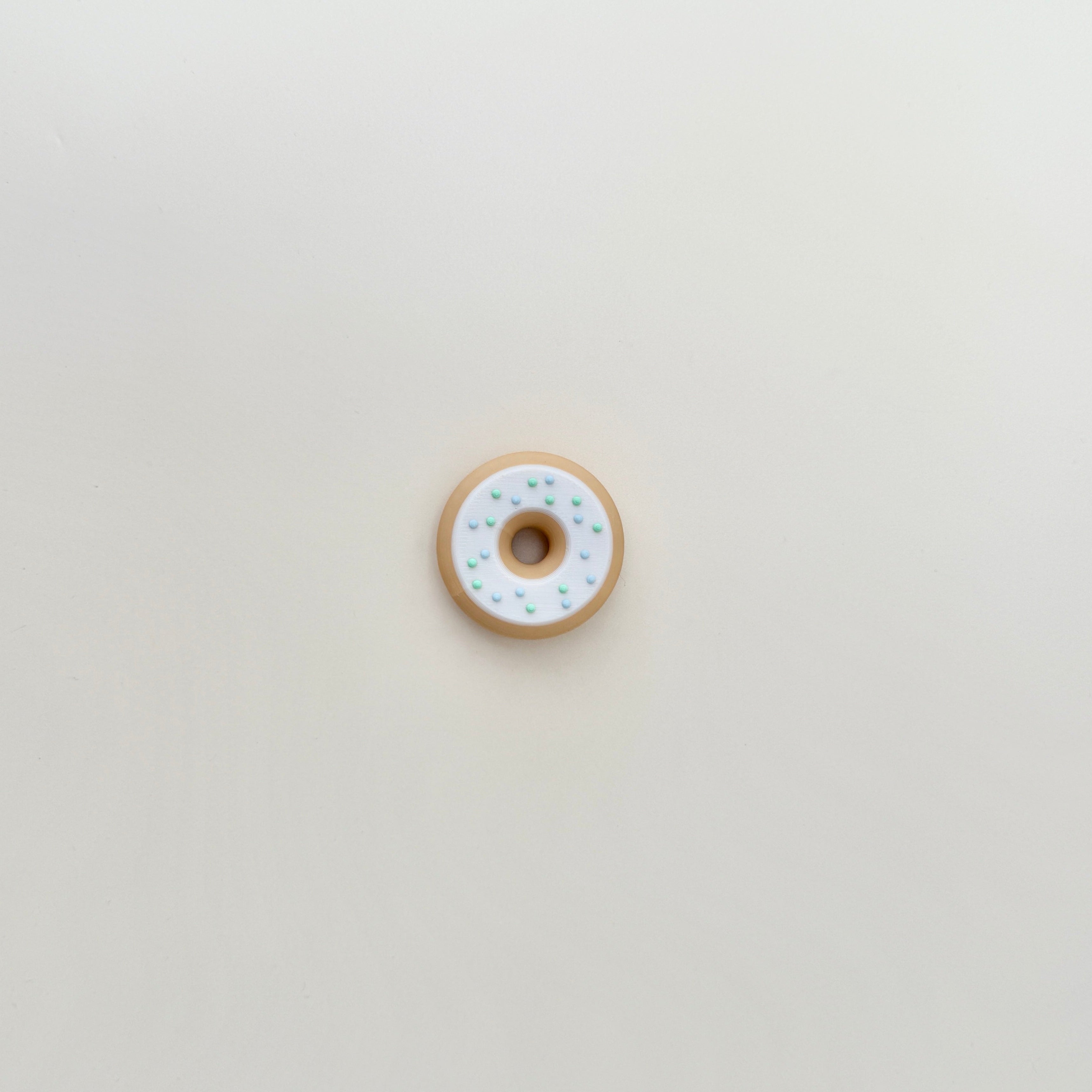 A smooth yet textured fidget toy with raised sprinkle details for added grip and a satisfying feel.