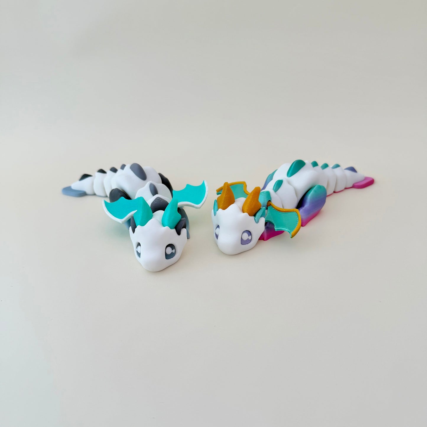 3D printed dragon with movable segments and wings, approx 16 cm, designed for satisfying hand movement.
