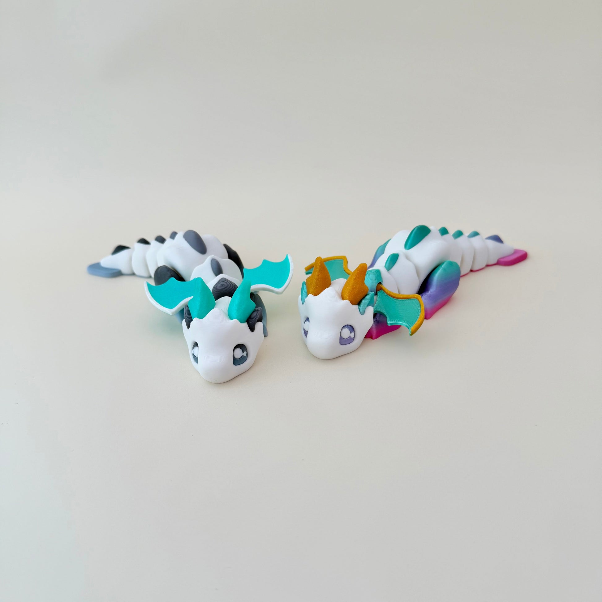 3D printed dragon with movable segments and wings, approx 16 cm, designed for satisfying hand movement.
