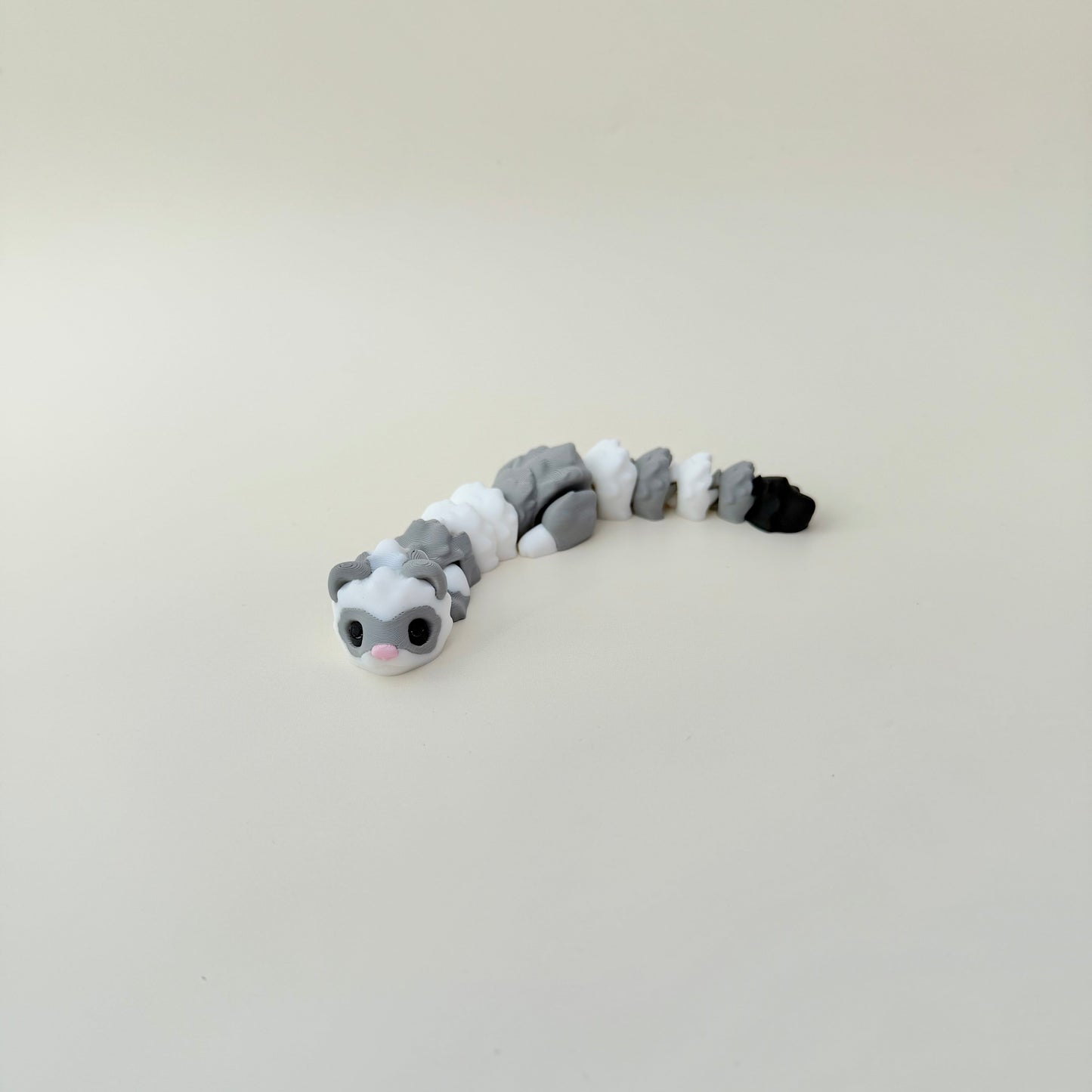 Articulated ferret fidget toy with raised texture for tracing and grounding during focus breaks.
