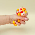 Textured quiet fidget designed for grounding and focus support, combining bumpy feel with visual motion inside.
