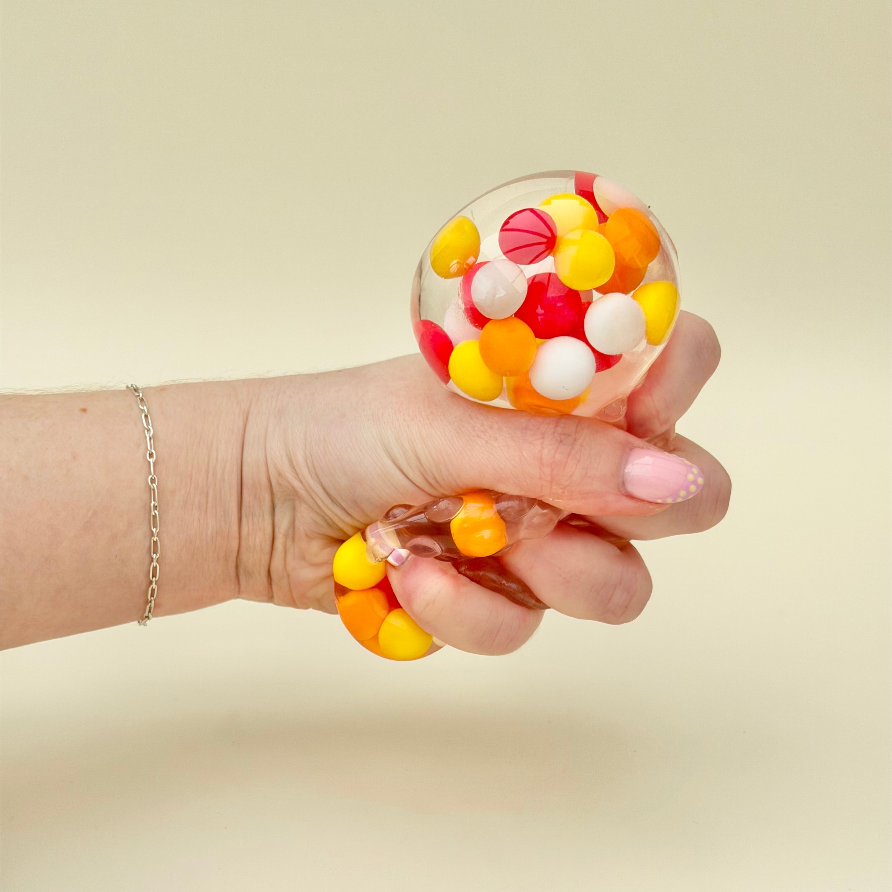 Textured quiet fidget designed for grounding and focus support, combining bumpy feel with visual motion inside.
