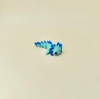 Handheld sensory dragon toy with raised texture and full-body movement for stimming support.