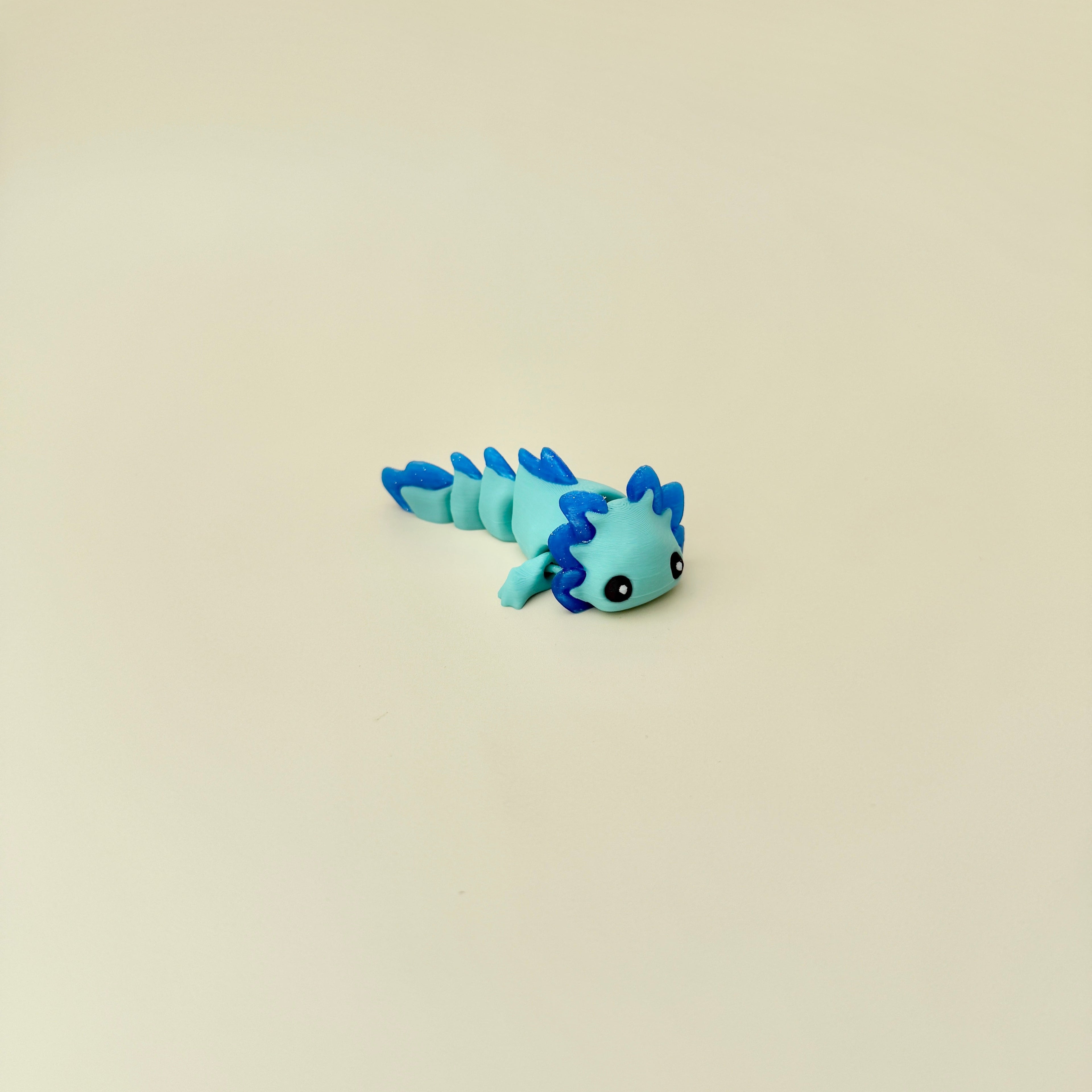 Handheld sensory dragon toy with raised texture and full-body movement for stimming support.