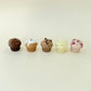 Mini muffin toys with raised icing, chips, or berries for sensory feedback.