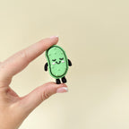 Green fidget toy with raised details and keychain loop, designed for tactile and click-based stimming.