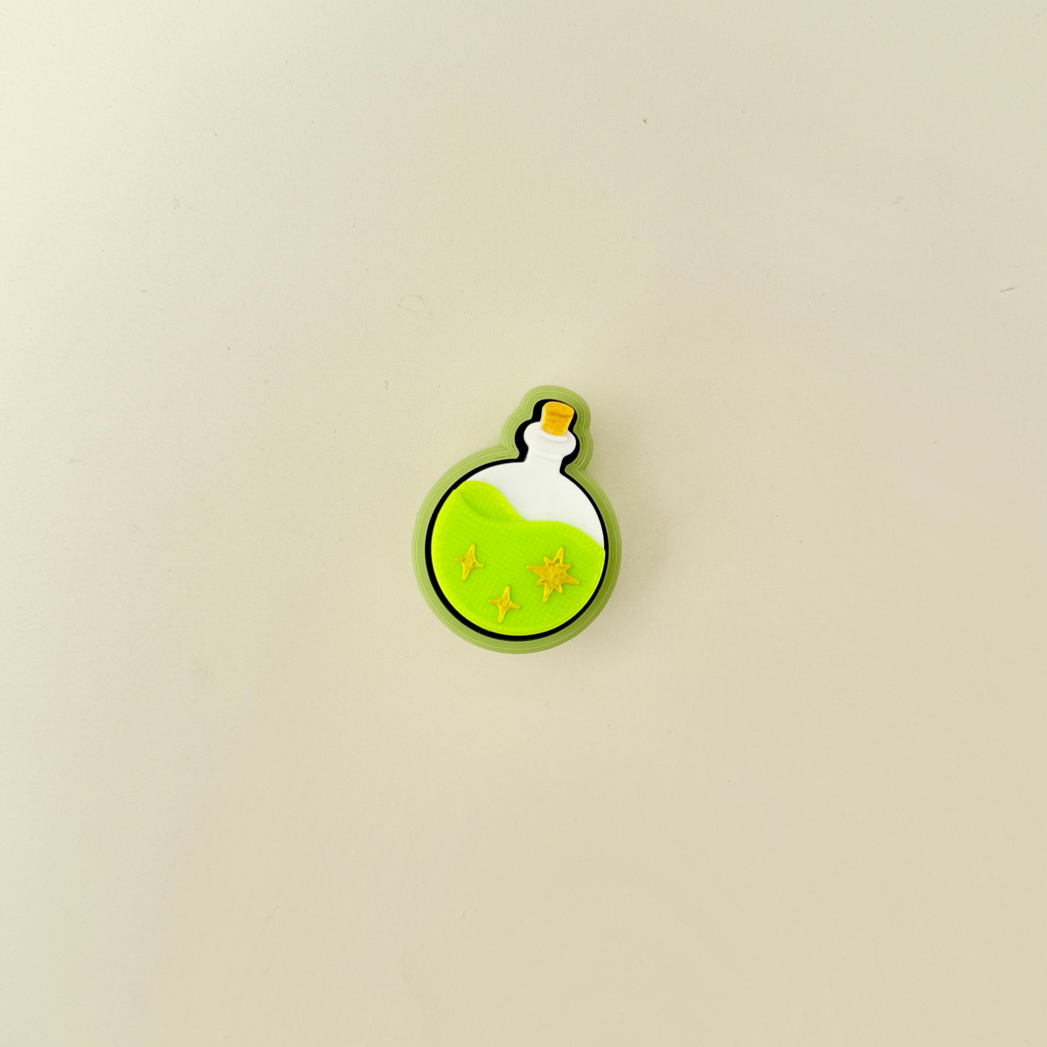 Potion-shaped fidget clicker with clickable centre and star texture on the surface